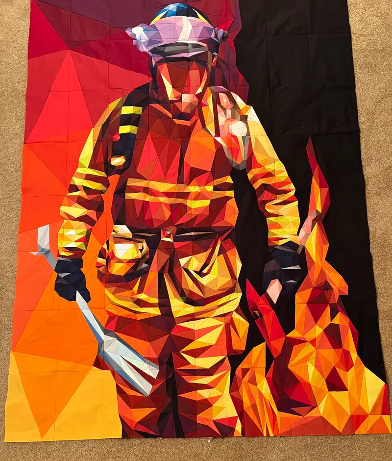Firefighter in turnout gear walking through flames
