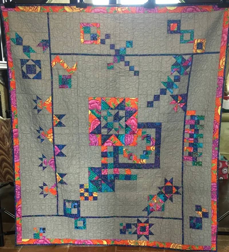 Modern sampler with jewel tone stars on gray linen
