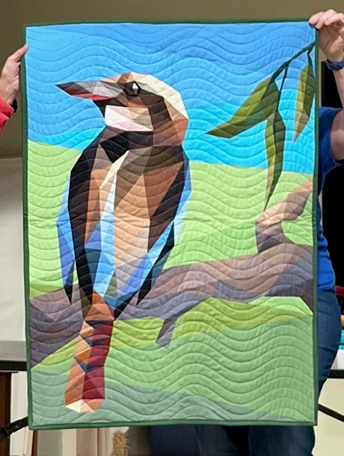 Kookaburra bird on branch with eucalyptus leaves