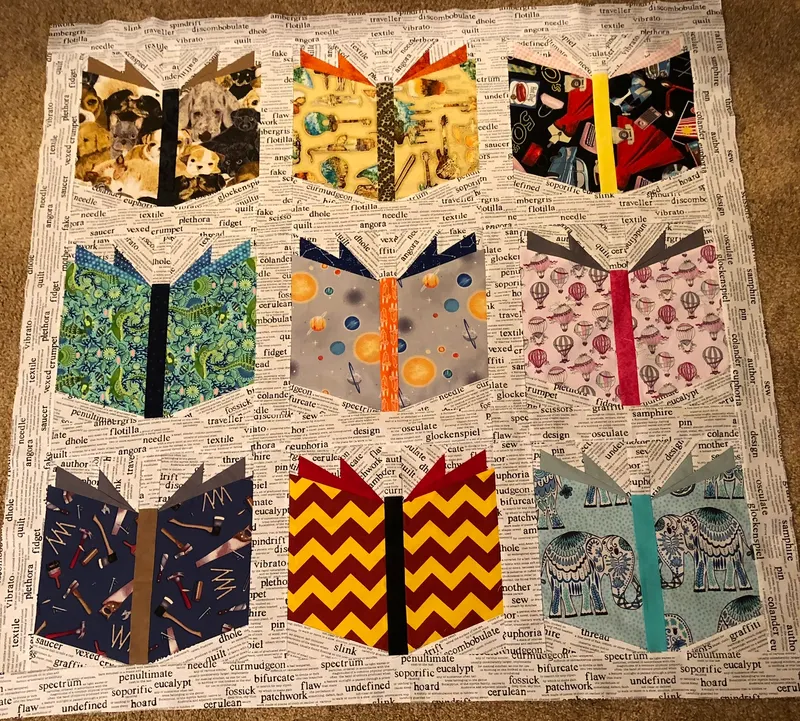 Nine open book blocks on newsprint fabric background