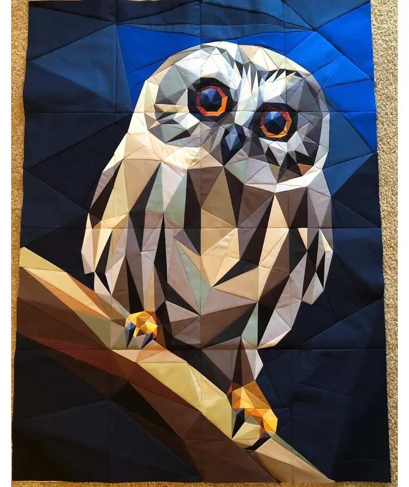Owl perched on branch with large orange eyes