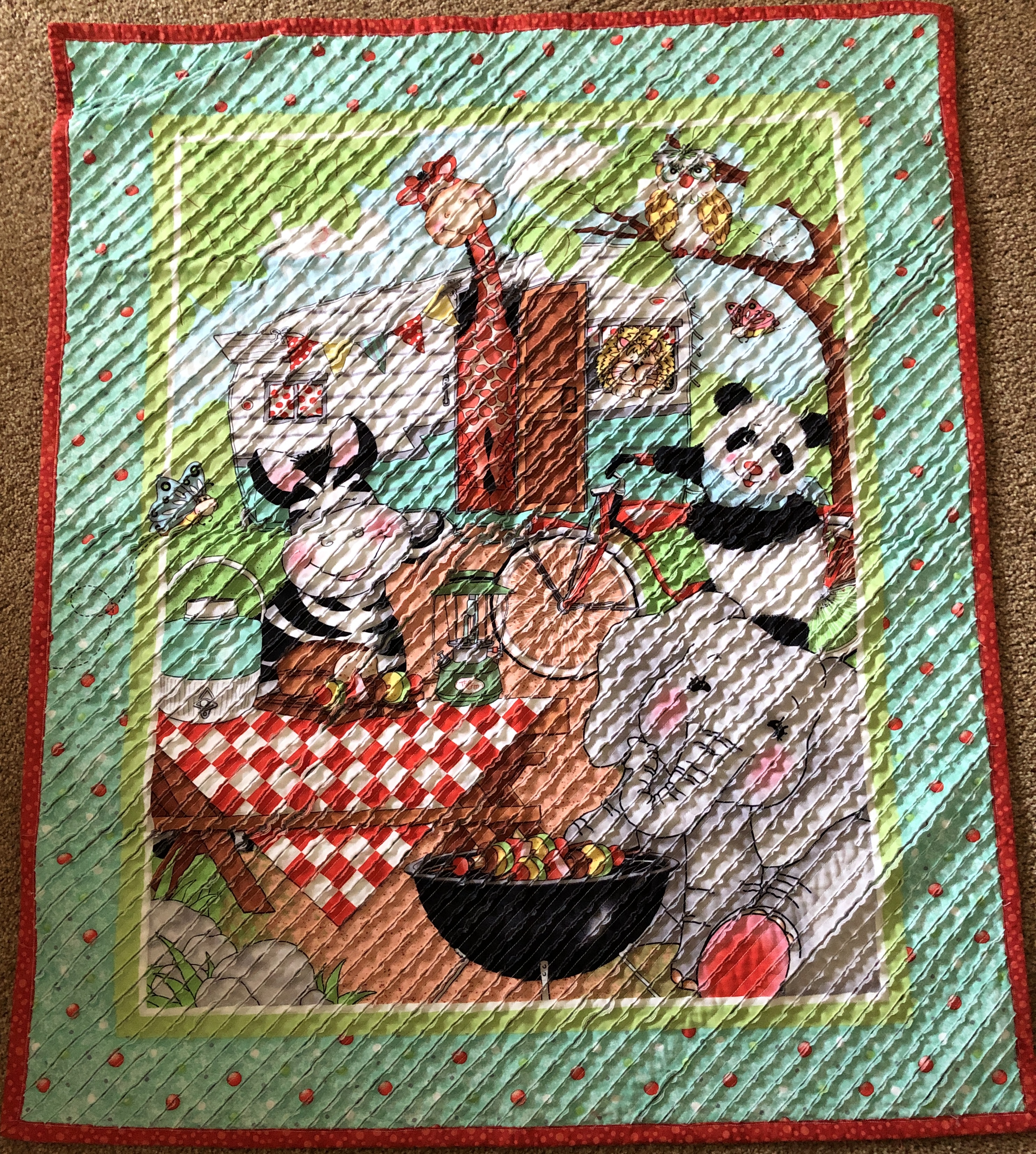 Whimsical baby quilt with cartoon animals at a barbecue