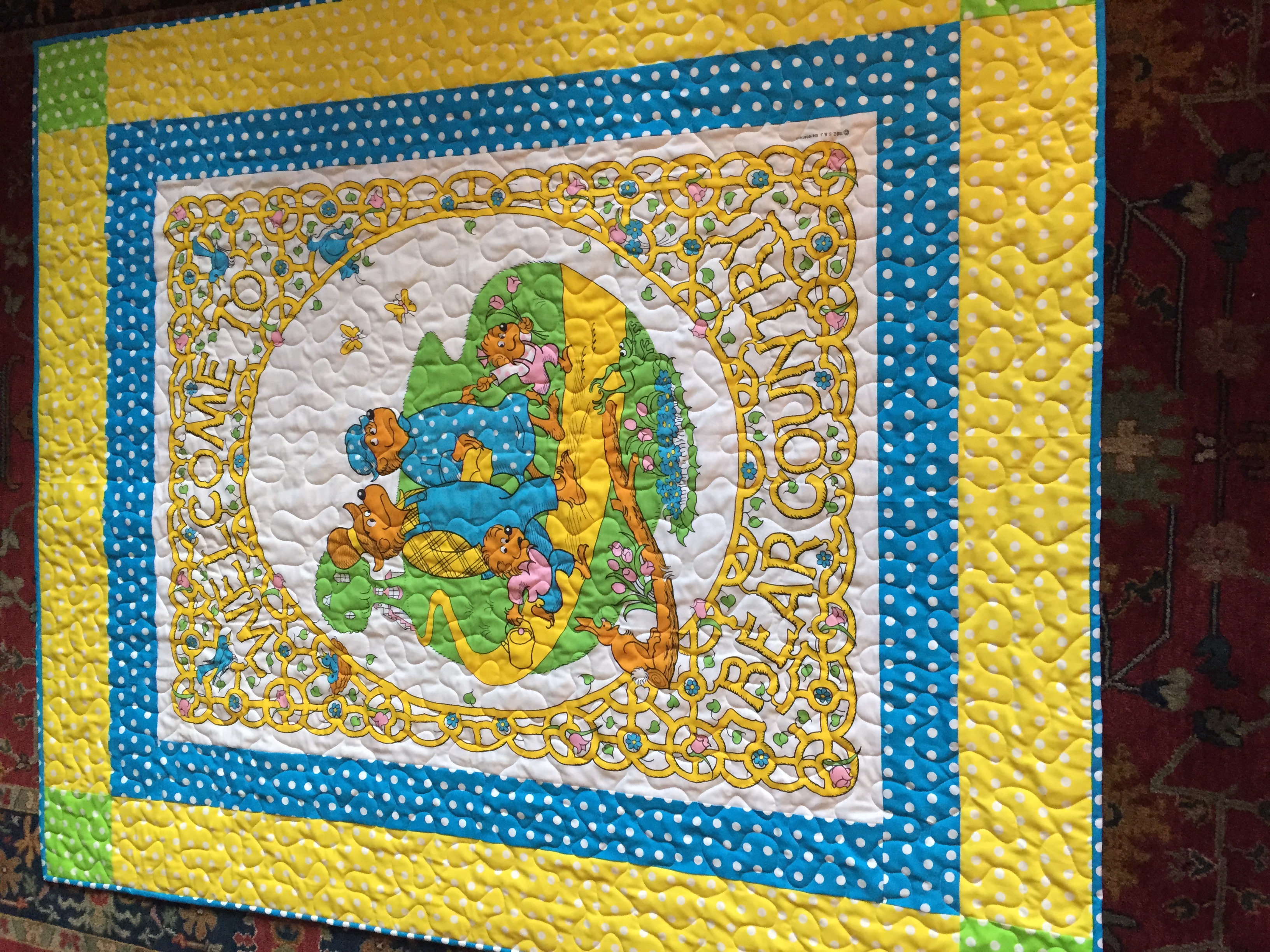 Baby quilt with cartoon bears and polka dot border