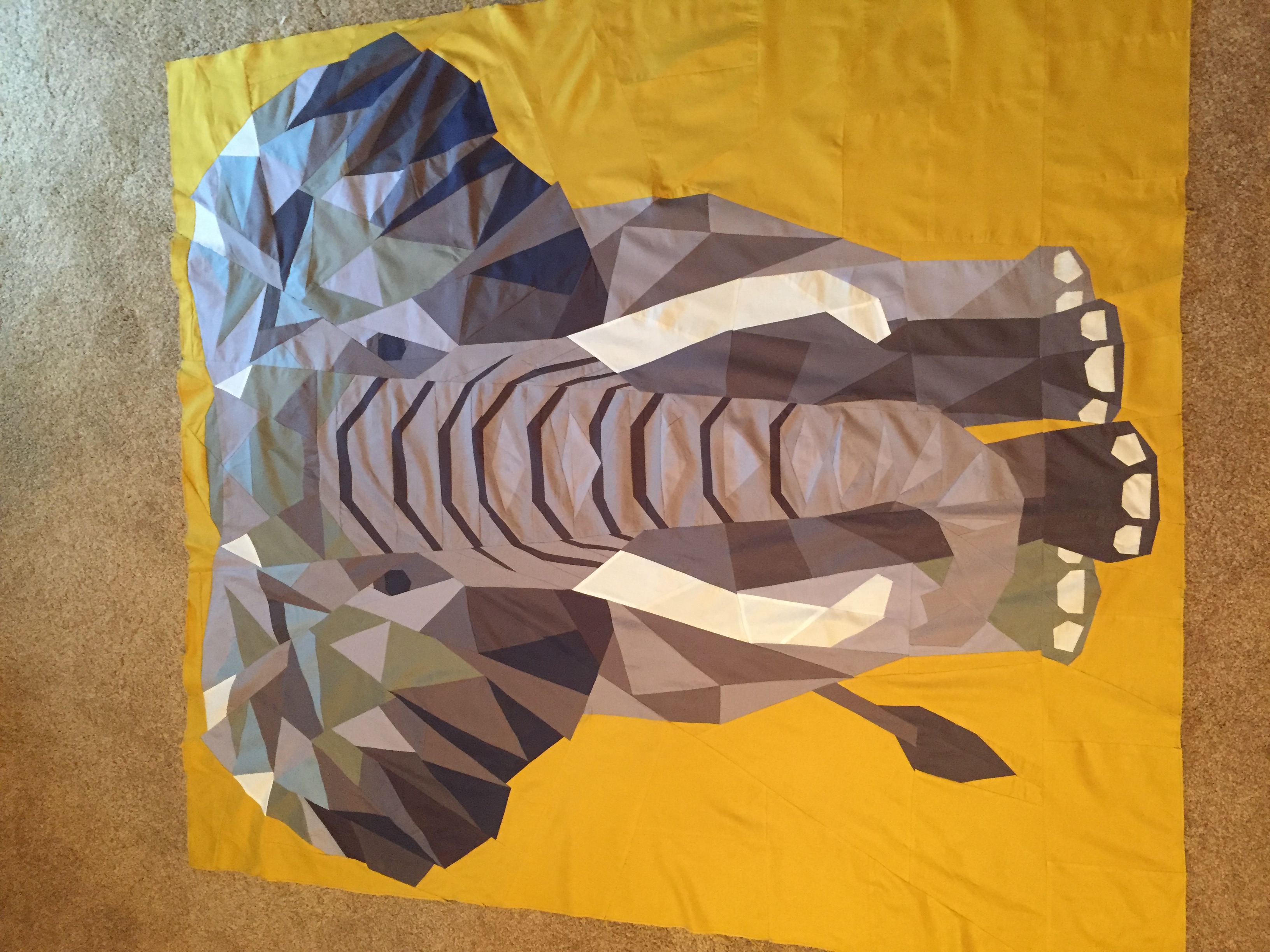 Geometric low-poly elephant on bold gold background