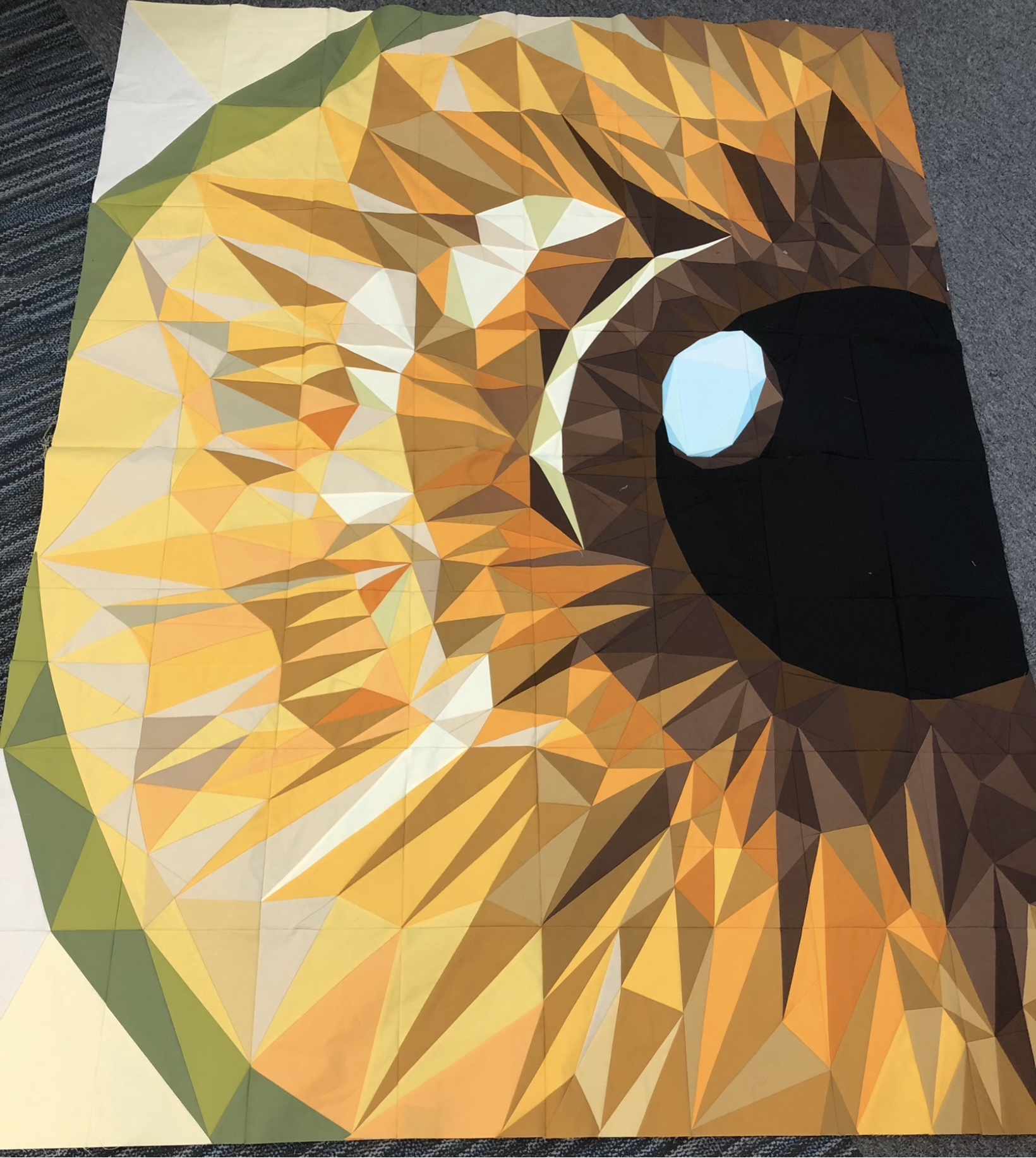 Golden owl eye in amber tones, geometric faceted style