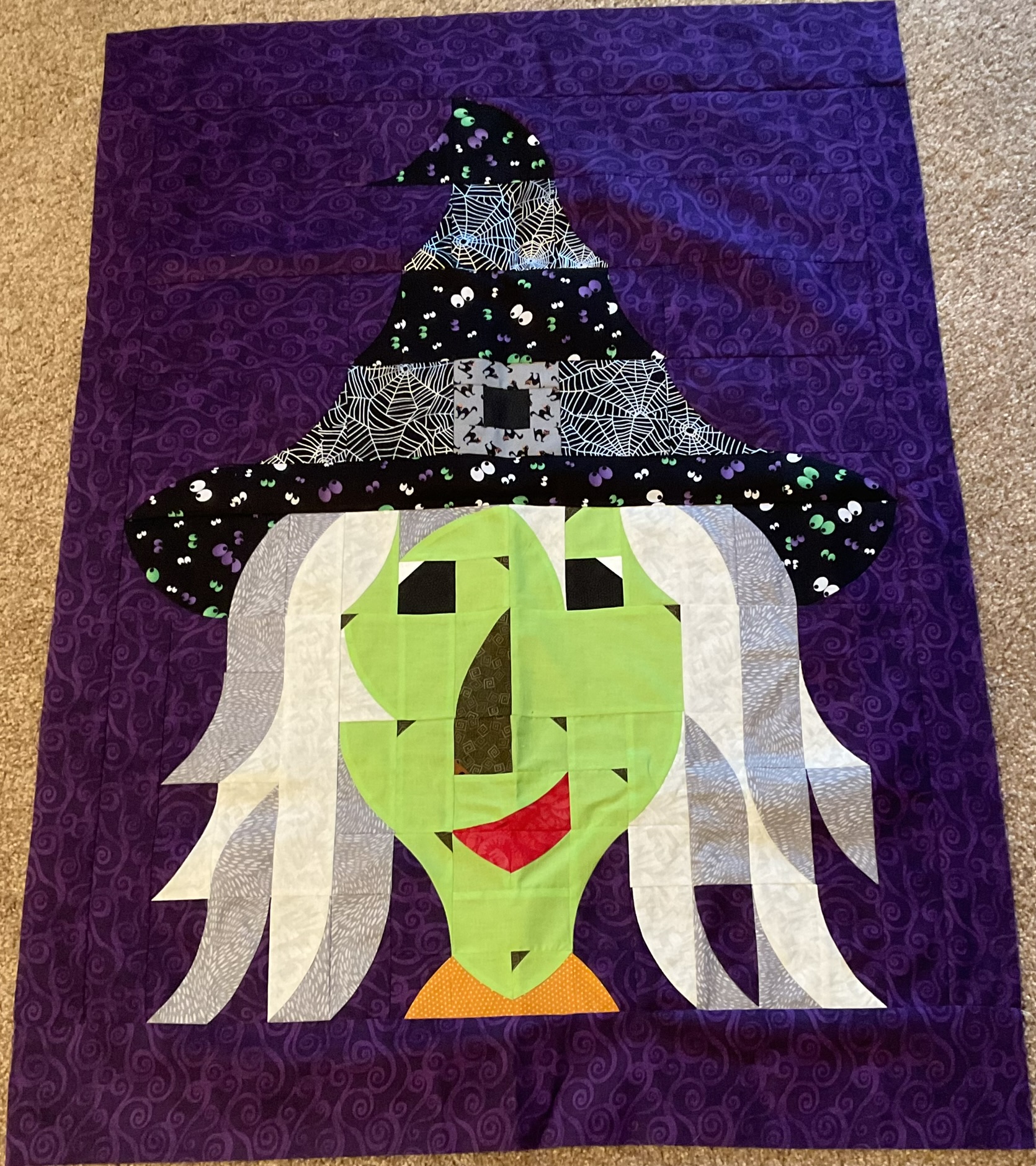 Halloween green-faced witch with spiderweb hat
