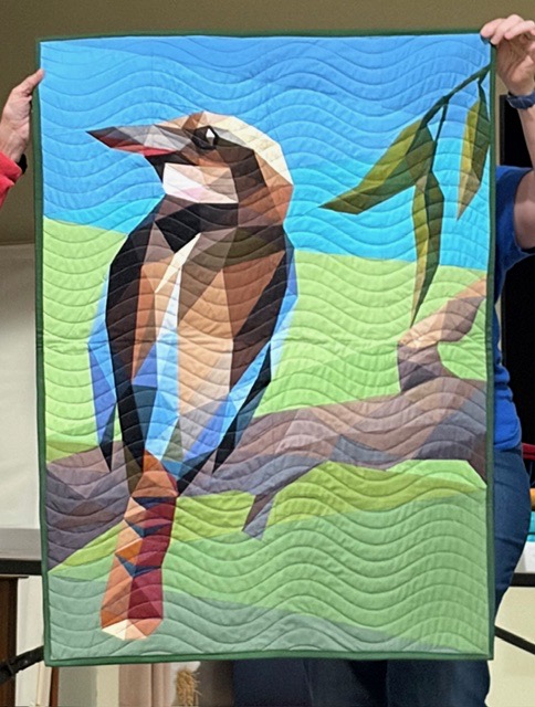 Kookaburra bird on branch with eucalyptus leaves