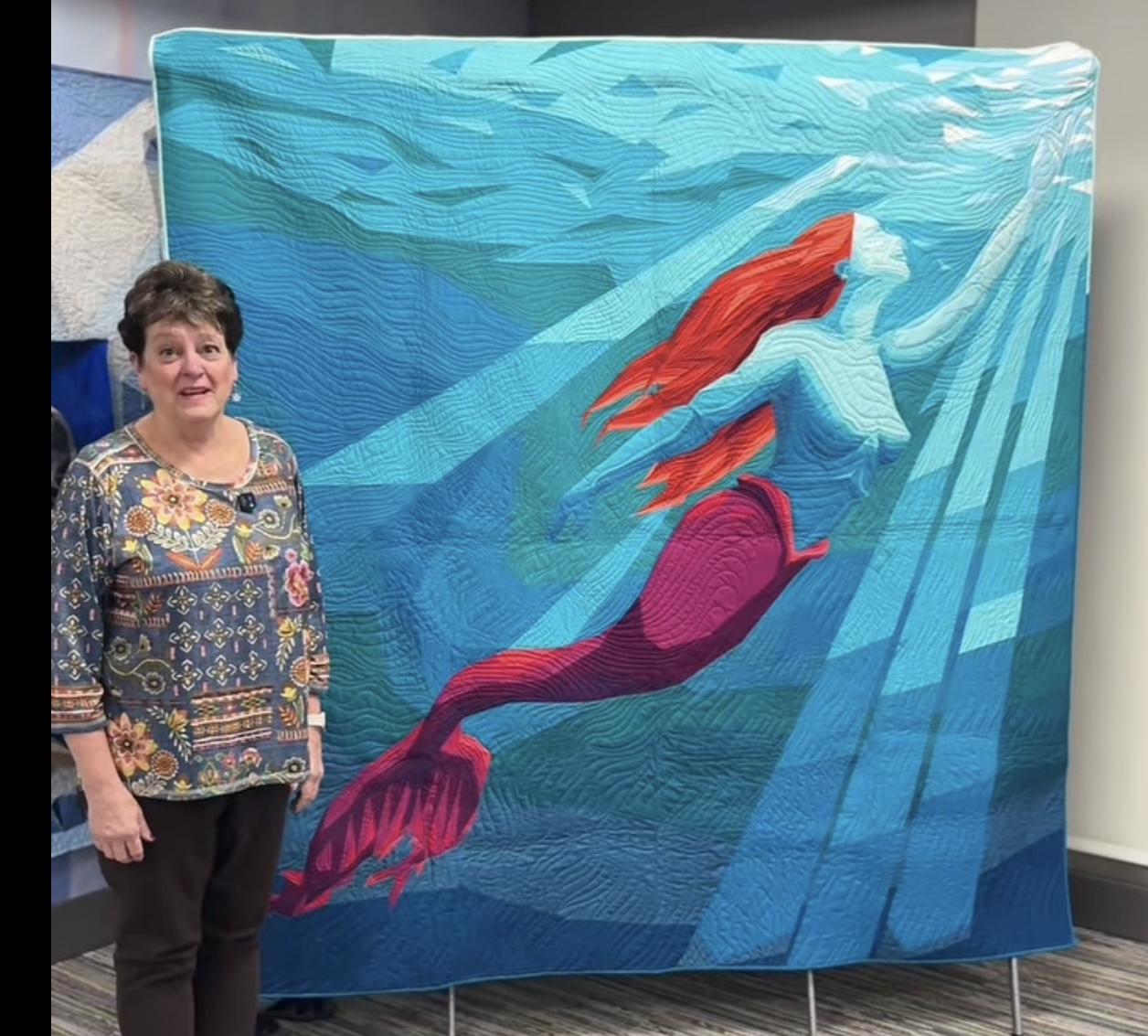 Mermaid swimming underwater with red hair