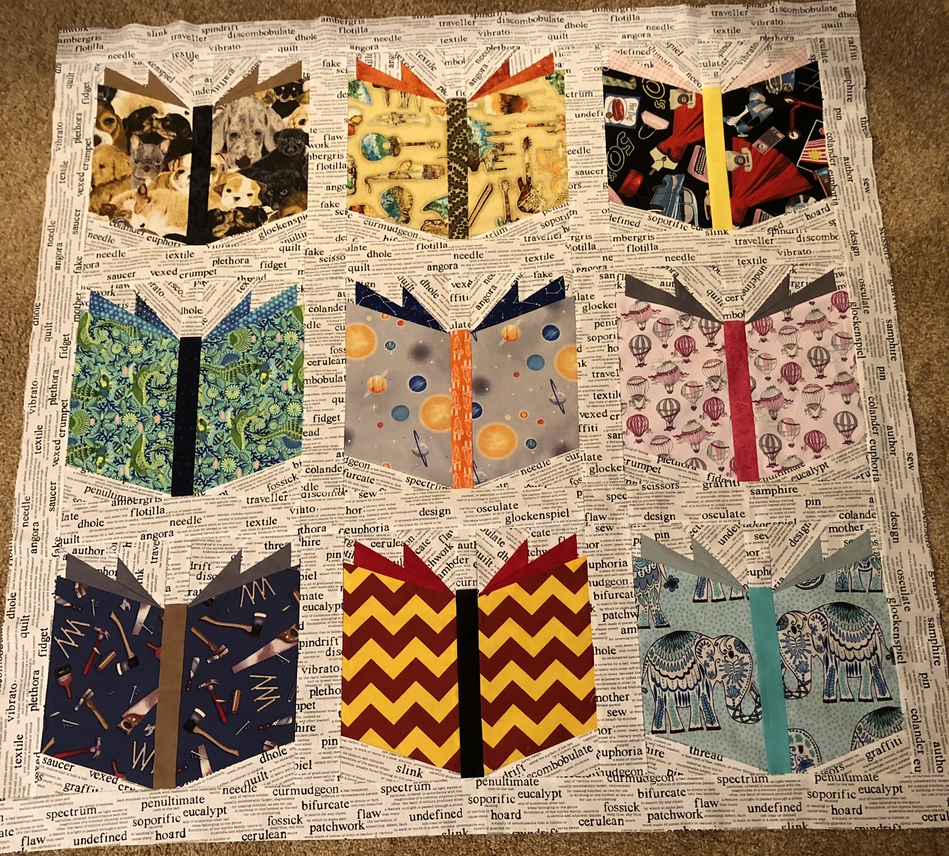 Nine open book blocks on newsprint fabric background