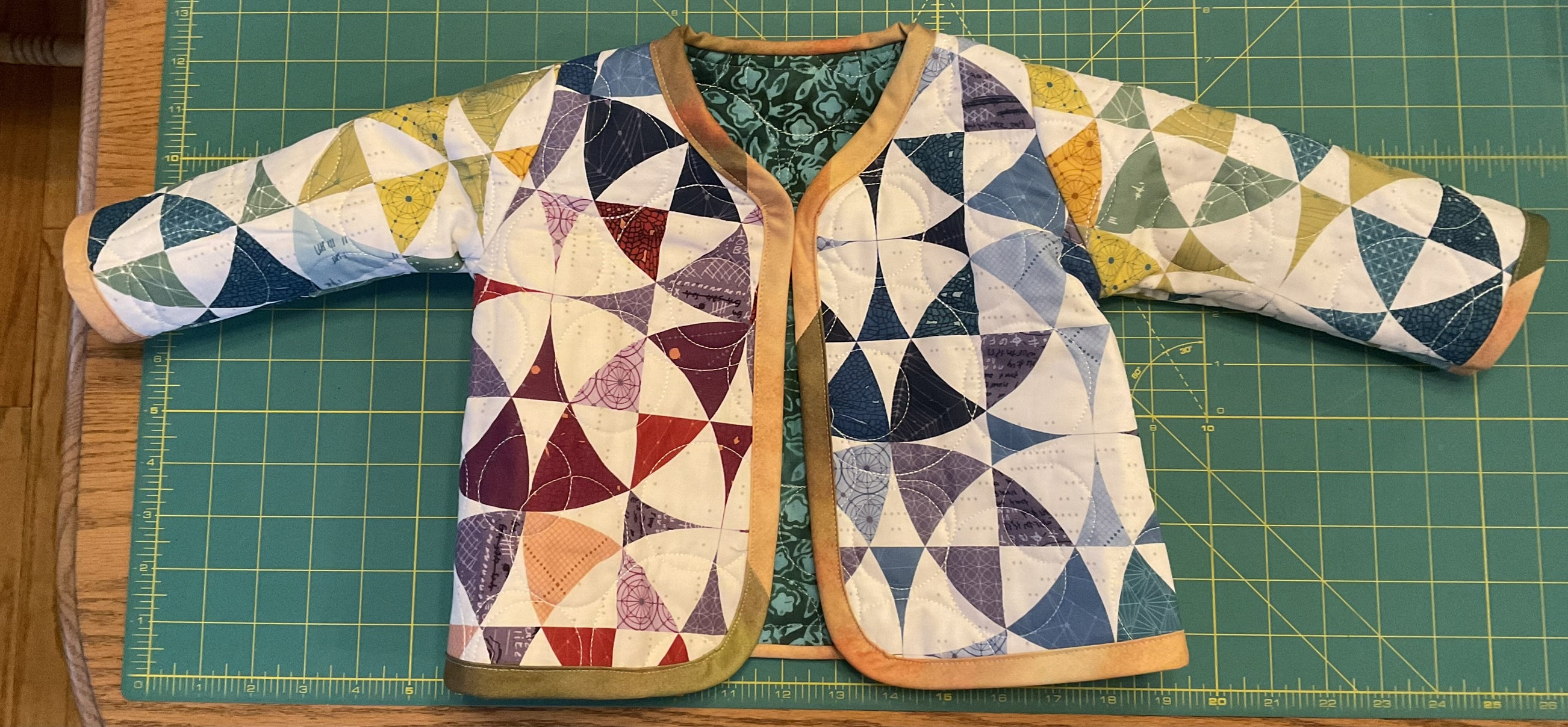 Quilted patchwork baby jacket in jewel tones