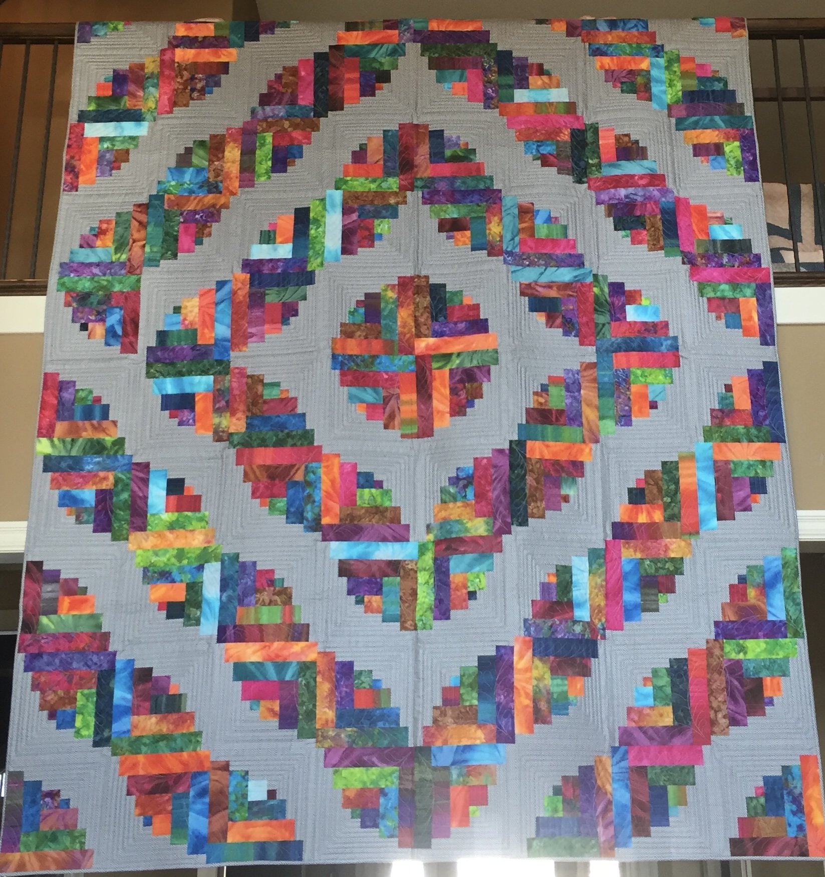 Rainbow log cabin blocks in vivid batik fabrics