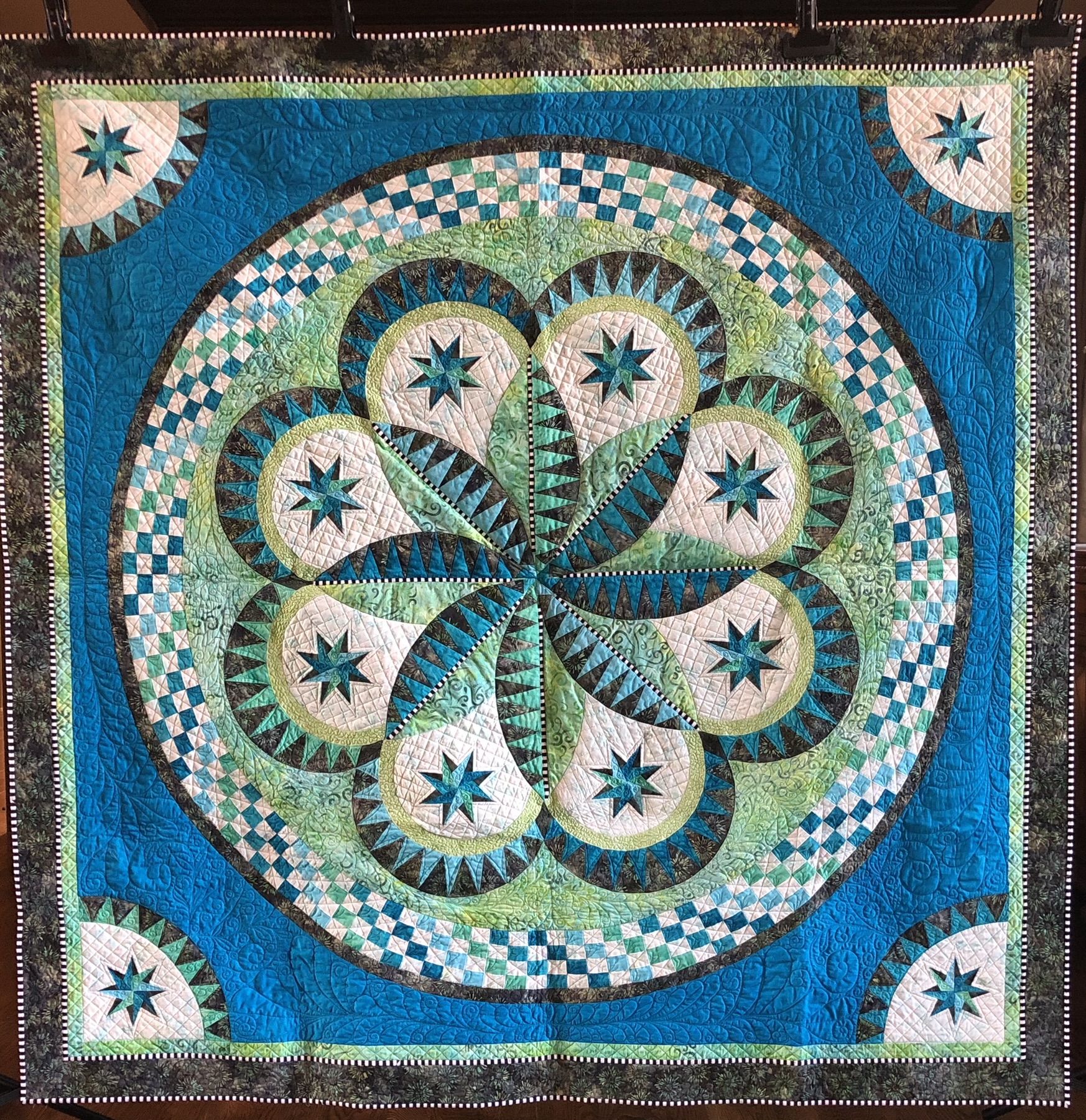 Intricate circular medallion in teal, green, and cream